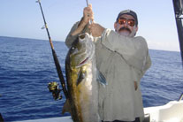 Skipper John Gooding hoists a large Amber Jack